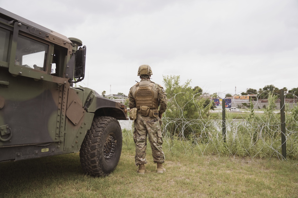 A National Guard member watches the Rio Grande River as Greg Abbott, governor of Texas, not pictured, tours the border between the US and Mexico along the Rio Grande River in Eagle Pass, Texas, US, on Monday, May 23, 2022.