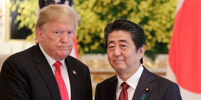 Former U.S. President Trump, left, and Japanese Prime Minister Shinzo Abe pose for a photo prior to their meeting at Akasaka Palace in Tokyo May 27, 2019. 