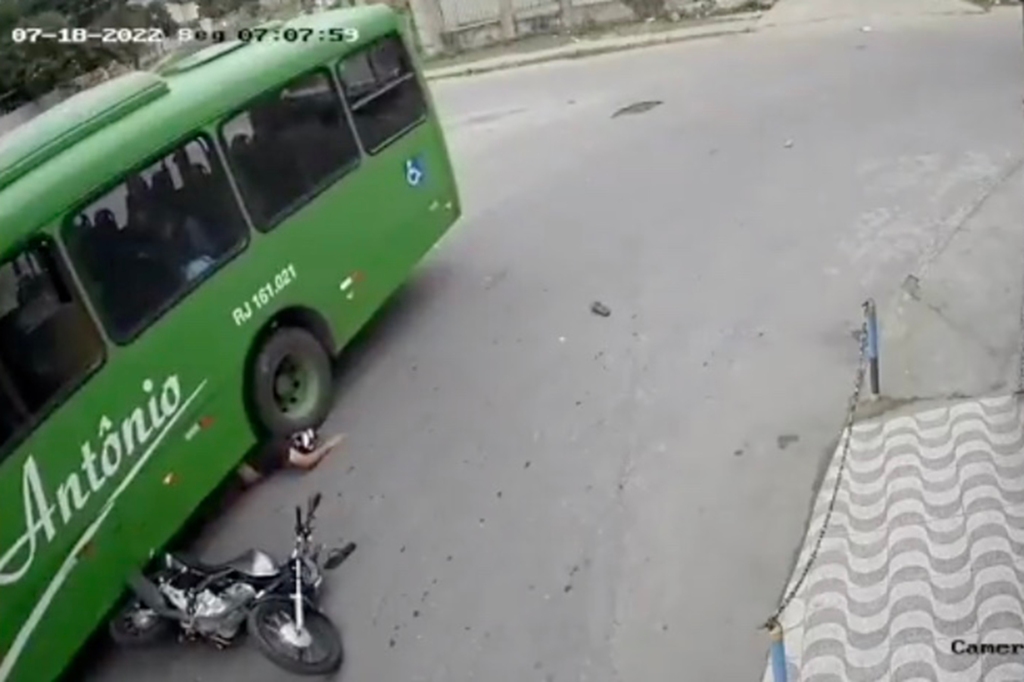 The man's helmet likely saved his head from getting crushed by the bus's tire. 