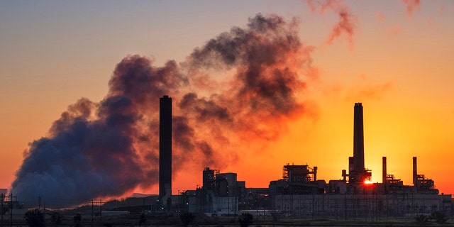 FILE - In this July 27, 2018, file photo, the Dave Johnson coal-fired power plant is silhouetted against the morning sun in Glenrock, Wyo. (AP Photo/J. David Ake, File)