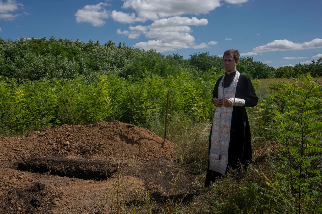 A priest prepares to pray over Anna Protsenko.