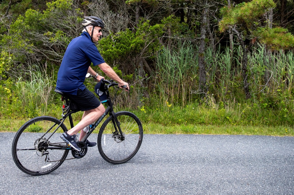 U.S. President Joe Biden rides his bike at Gordons Pond in Rehoboth Delaware, U.S., July 10, 2022.