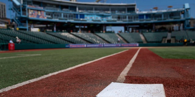 Larger bases are installed on the infield before a minor league baseball game between the Brooklyn Cyclones and Greensboro Grasshoppers, Wednesday, July 13, 2022, in the Coney Island neighborhood of the Brooklyn borough of New York. Major League Baseball is considering a pitch clock for next year along with shift limits, larger bases and restrictions on pickoff attempts.  