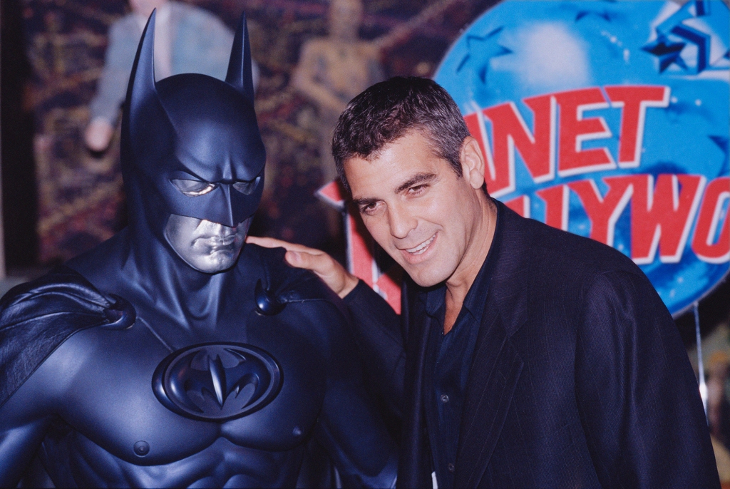 George Clooney poses with a model of Batman during a photocall for his "Batman & Robin" at Planet Hollywood, in London, UK on June 23, 1997.