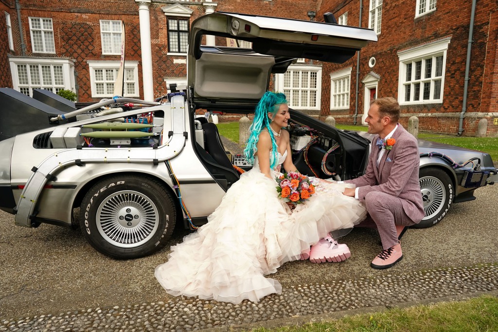 Couple finally celebrate their lockdown marriage with an epic Back To The Future themed wedding. Sci-fans Jordan, 33, and Pete Ayriss, 38, were able to celebrate their love in true 80s style last month.See SWNS story SWCAfuture. The pair from Ravenswood, Suffolk, married with just a dozen of their closest relatives in lockdown at the Manor Room in Christchurch Mansion.With many nods to the film on display, the biggest attraction of all was when the pair arrived in a replica DeLorean.Pete, who is originally from Felixstowe, said: "We are fans, every now and again we will have a Back To The Future off and throw each other trivia, throw out movie quotes at each other."It is a completely iconic trilogy and we do hope they never do anything else with it again. We did see the show and that was amazing."