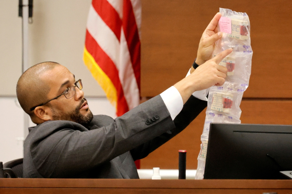 BSO crime scene detective Miguel Suarez displaying bullet casings from the scene of the shooting.