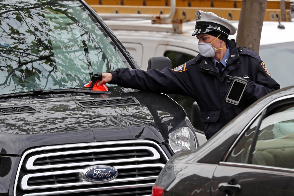 5/18/20 - A New York City Traffic Agent placing a ticket on a vehicle for in violation of alternate side of the street parking on 1st avenue in Manhattan. Nypostinhouse

Photo by Charles Wenzelberg / New York Post