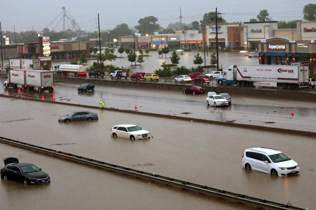 Abandoned cars are scattered by flooding across a shuttered Interstate 70 at Mid Rivers Mall Drive in St. Peters after heavy rain fell through the night and into the morning on Tuesday, July 26, 2022. (Robert Cohen/St. Louis Post-Dispatch via AP)