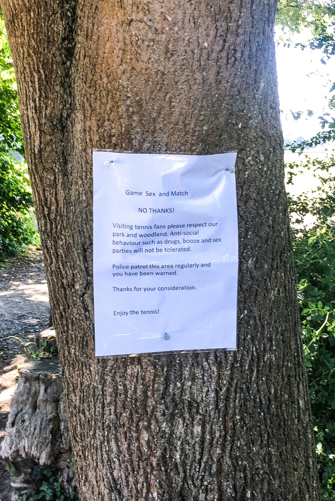 Neighbors say Wimbledon fans have long had hookups in the woods by the stadium — leading to signs like the one above.