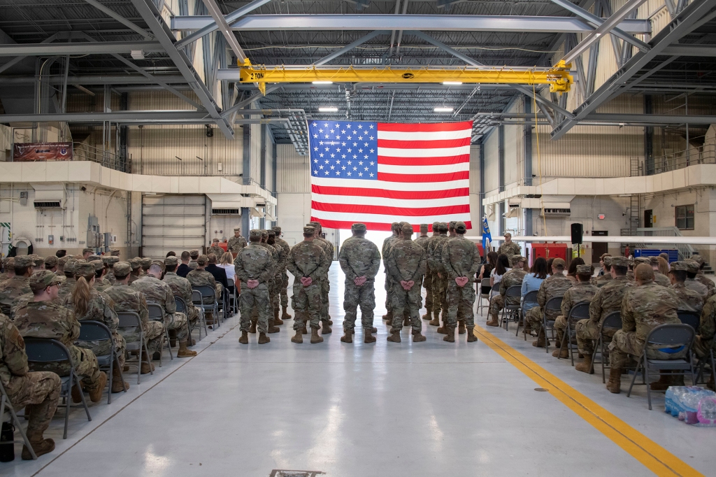 Airmen from the 319th Aircraft Maintenance Squadron stand at parade rest during the 319th AMXS change of command ceremony in a hangar, June 10, 2022, at Grand Forks Air Force Base, North Dakota.