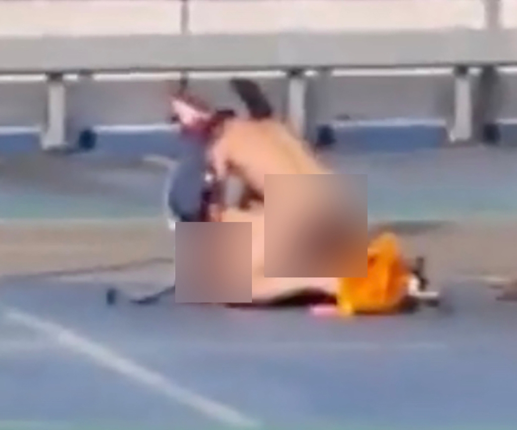 The 8-second video shows the pair stark naked and engaged in doggy-style sex on the parking lot roof. 