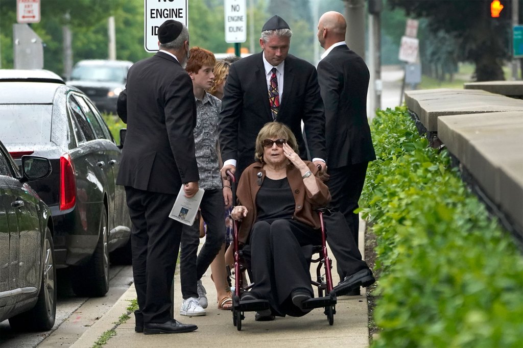 Linda Straus, widow of Stephen Straus, arrives for a funeral service with family members at the Jewish Reconstructionist Congregation.