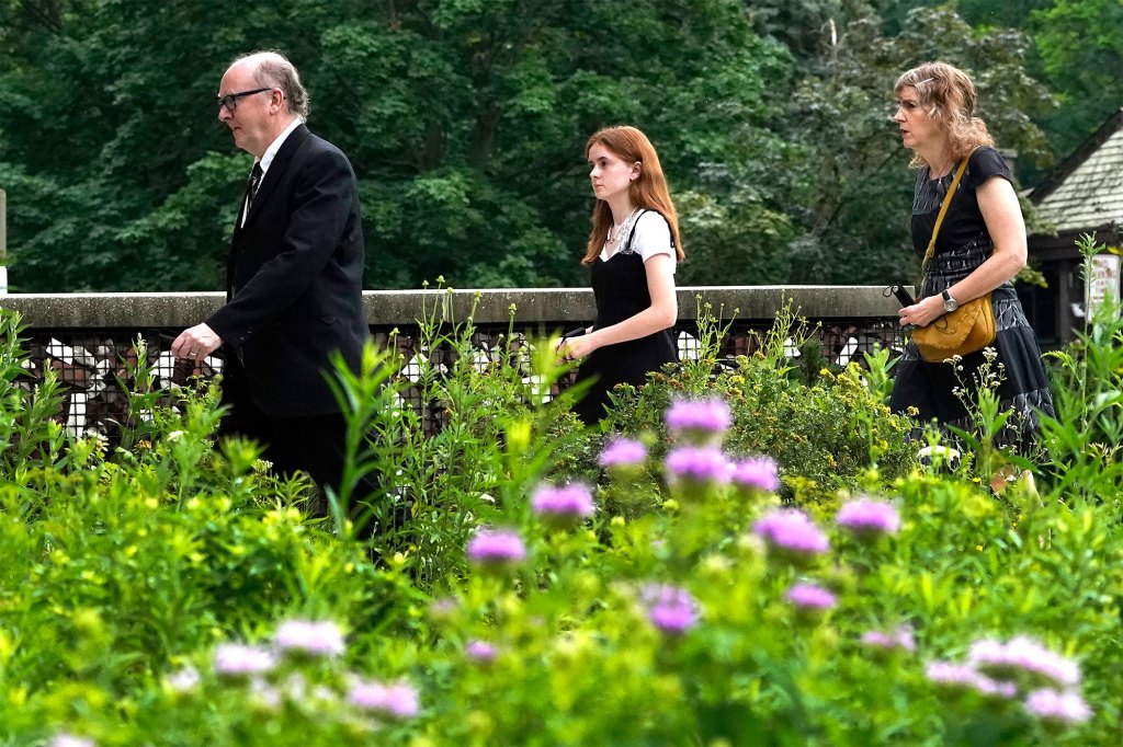 Mourners arrive for the funeral service for Stephen Straus.