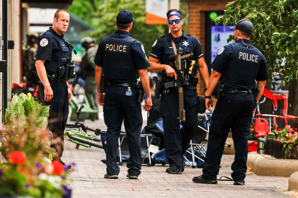 Law enforcement officers investigate the scene of a mass shooting at a 4th of July celebration and parade in Highland Park, Illinois, USA, 04 July 2022.