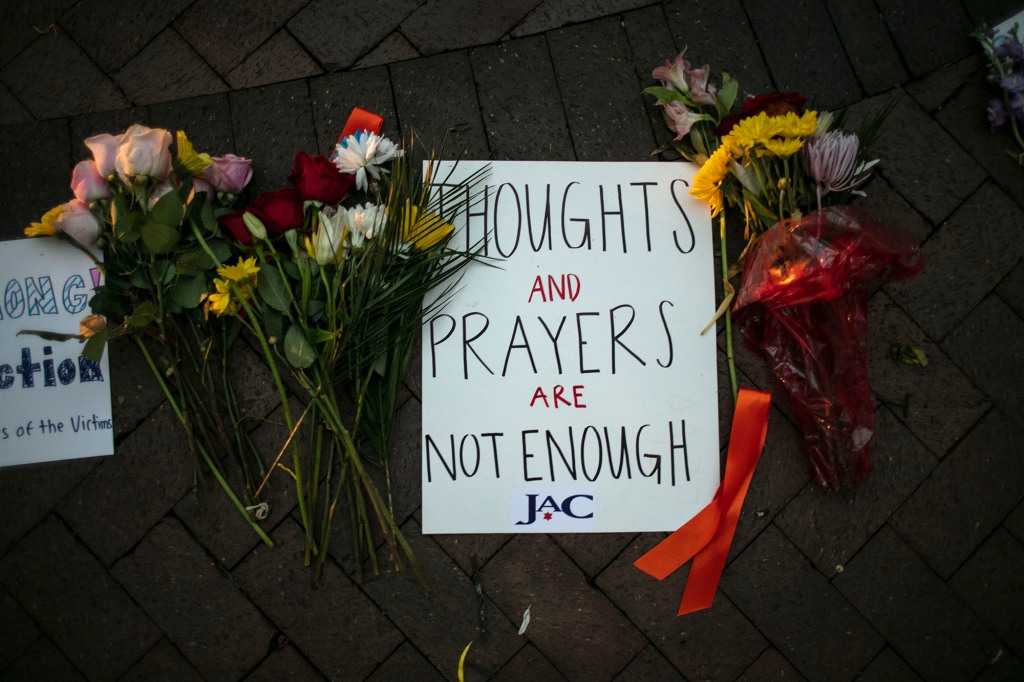 Message at a Highland Park vigil says that "thoughts and prayers are not enough."