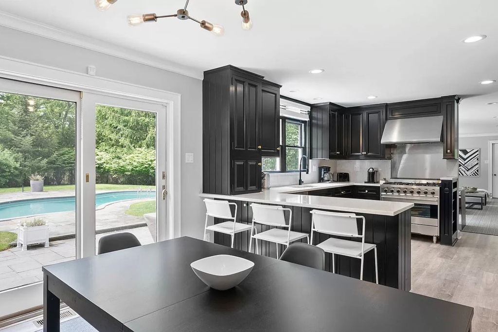 The kitchen with breakfast bar seating and a breakfast area.