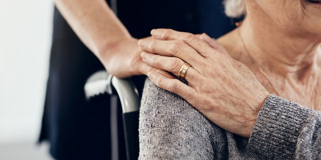 Cropped shot of a female caregiver comforting a senior woman