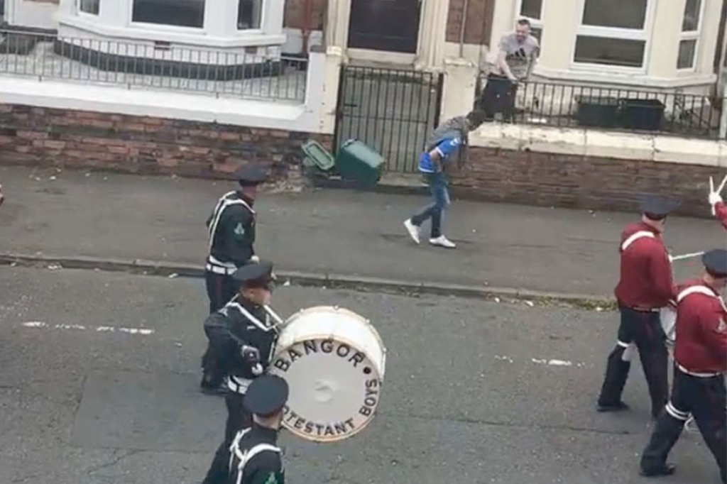 Irish man throws garbage can at marching band in hilarious video