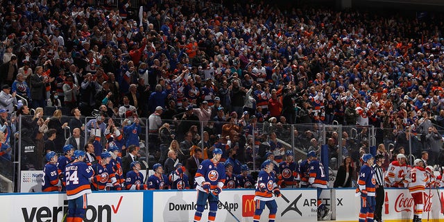 Fans celebrate a first-period goal by Brock Nelson (29) of the New York Islanders, the first in the new building, against the Calgary Flames at the UBS Arena Nov. 20, 2021, in Elmont, N.Y.