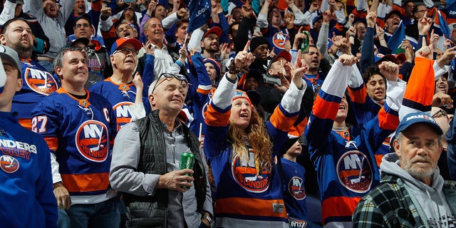 Fans celebrate a first-period goal by Brock Nelson of the New York Islanders, the first goal scored at UBS Arena Nov. 20, 2021, in Elmont, N.Y. 