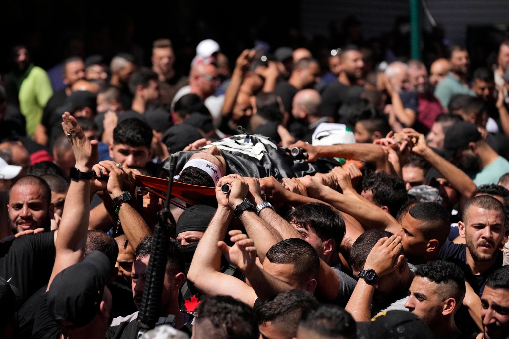 Palestinian mourners carry Muhammad Al-Azizi.