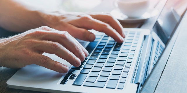 A man working on a laptop.