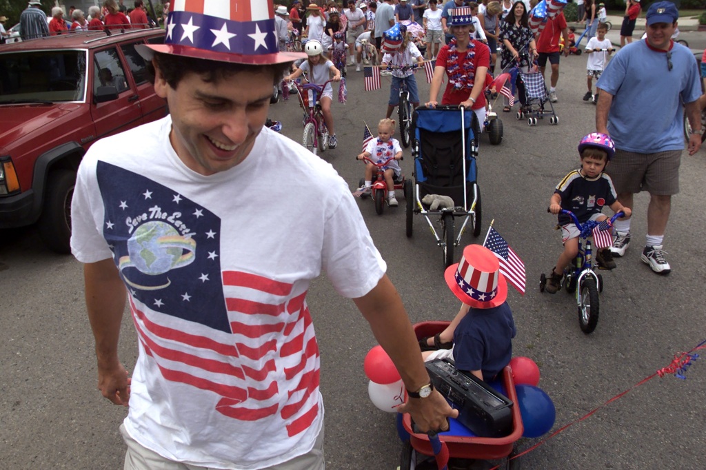 Wayne Cotter tows his son, Isaac, at a 4th of July parade in Sherman Oaks, Los Angeles, circa 2000.