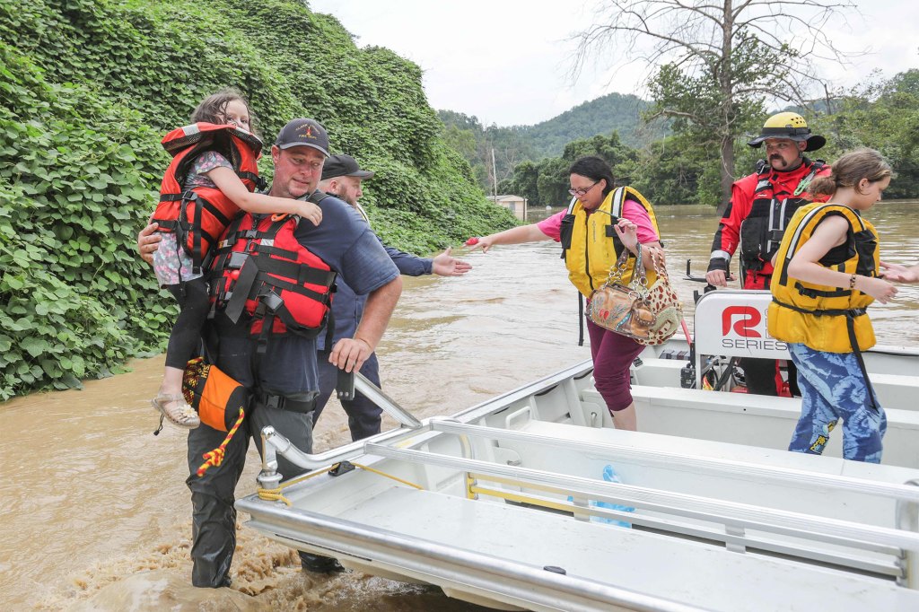 A group of stranded people are rescued from the flood waters of the North Fork of the Kentucky River in Jackson, Kentucky on July 28, 2022.