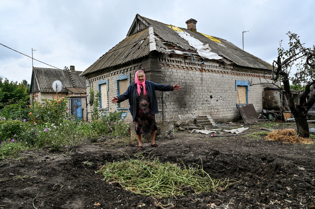 An elderly woman is seen outside her house damaged by the russian shelling, Prymorske village, Zaporizhzhia Region, southeastern Ukraine.