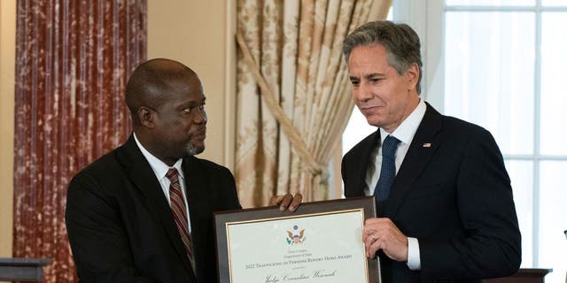 US Secretary of State Antony Blinken presents the 2022 Trafficking in Persons Hero Award to Judge Cornelius Wennah, of Liberia, during the 2022 Trafficking in Persons (TIP) Report launch ceremony