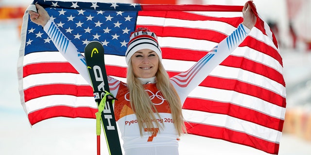 Bronze medal winner Lindsey Vonn celebrates during the flower ceremony for the women's downhill at the 2018 Winter Olympics.