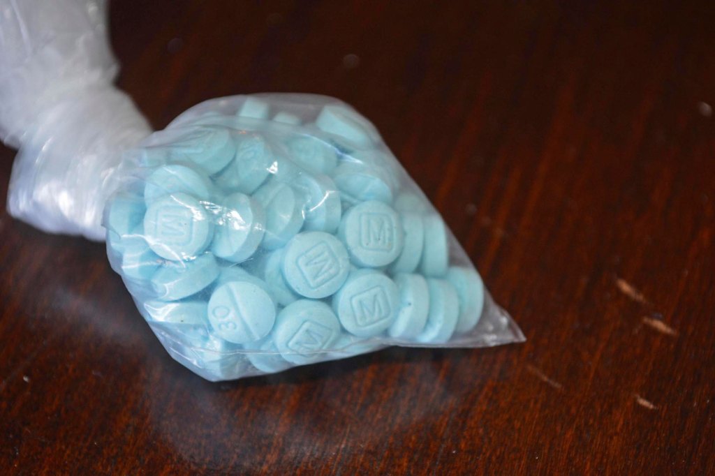 This undated file photo provided by the U.S. Drug Enforcement Administration's Phoenix Division shows a closeup of fentanyl-laced sky blue pills.