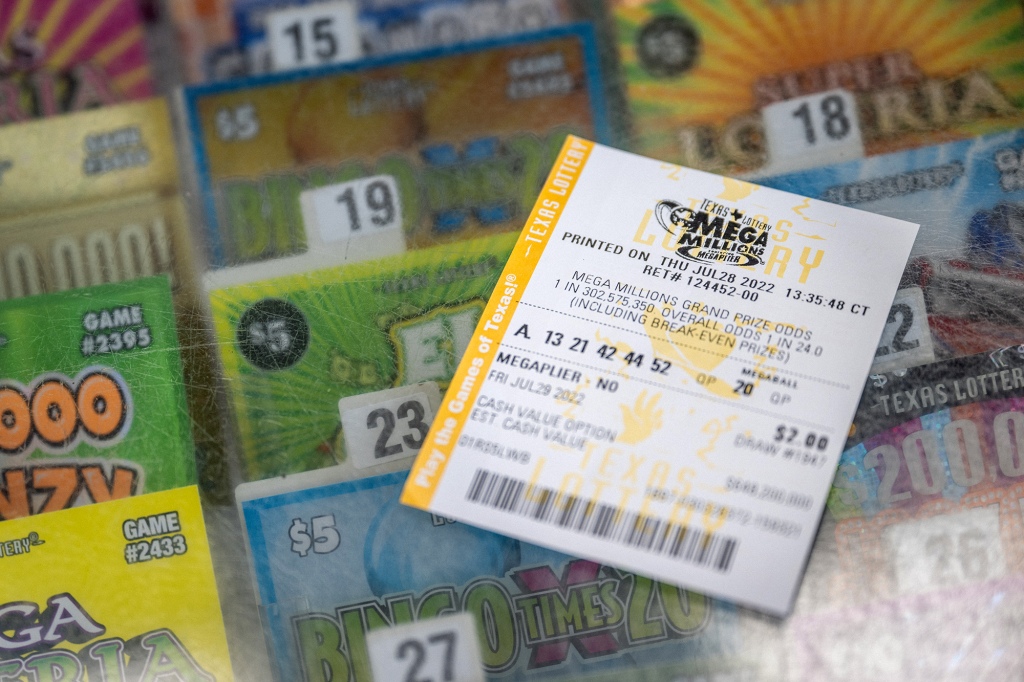 In this photo illustration, a lottery ticket is shown on a Chevron gas station countertop on July 28, 2022 in Houston, Texas.