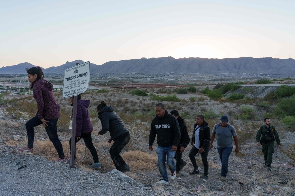 Migrants are apprehended by United States Border Patrol agents while attempting to cross the US-Mexico border near Mount Cristo Rey in Sunland Park, New Mexico, on June 3, 2022. - The area around Mount Cristo Rey is a busy corridor for migrants attempting to sneak into the United States without being caught.