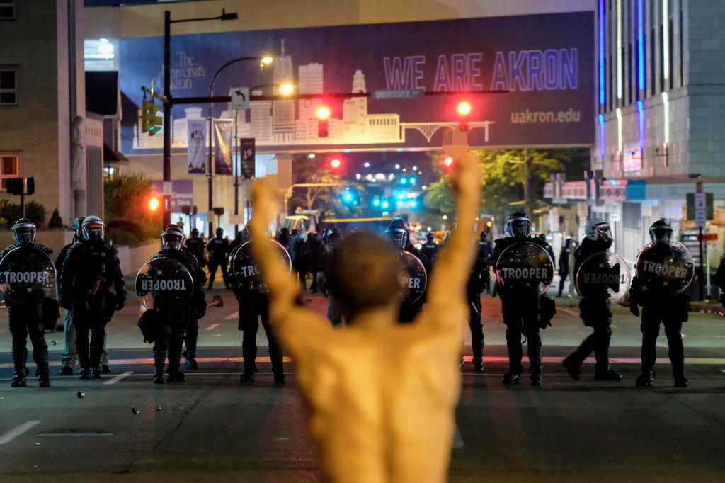 Tear gas was deployed after protesters set a dumpster on fire and attempted to move barricades in downtown Akron Sunday.