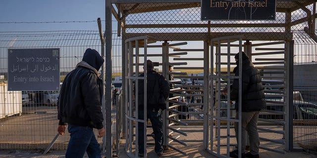 Palestinian workers enter Israel after crossing from Gaza on the Israeli side of Erez crossing between Israel and the Gaza Strip, March. 27, 2022.