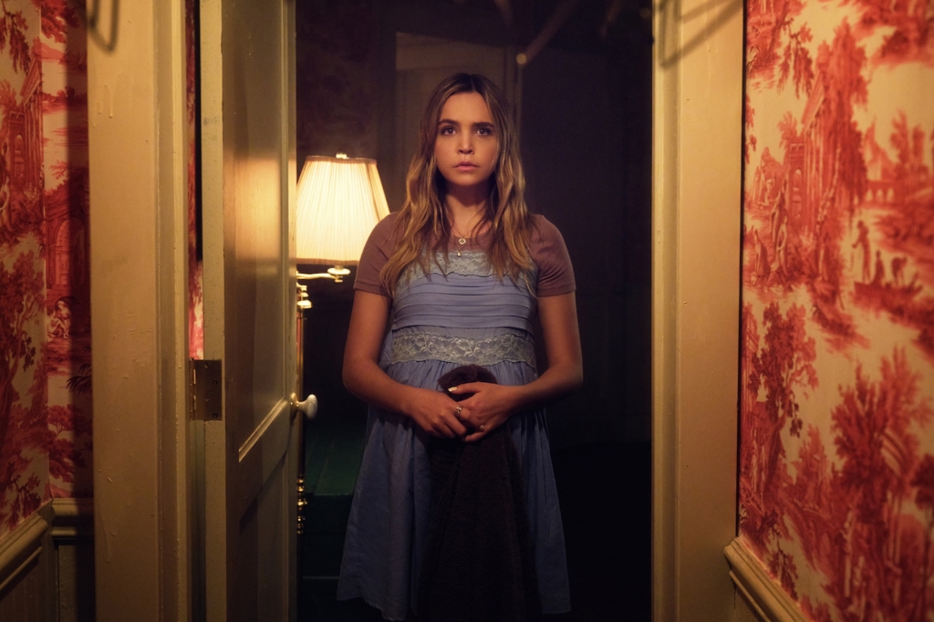 Pregnant teen Imogen (Bailee Madison) stands in a hallway with blood on the walls in "Pretty Little Liars: Original Sin." 