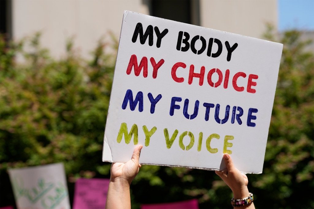 A woman supporting abortion-rights holds a sign outside the South Carolina Statehouse on Thursday, July 7, 2022, in Columbia, S.C.