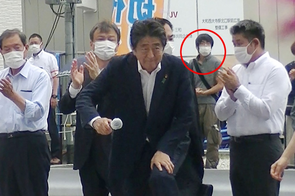 Killer pictured behind ex-Japanese leader Shinzo Abe moments before he shoots him dead.
