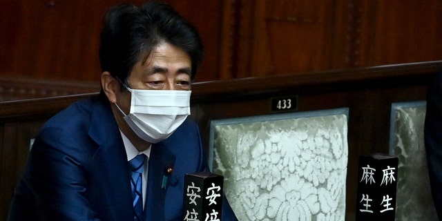 Japan's Former Prime Minister Shinzo Abe attends the lower house plenary session of parliament to elect the prime minister of Japan, in Tokyo on November 10, 2021. (Photo by CHARLY TRIBALLEAU / AFP) (Photo by CHARLY TRIBALLEAU/AFP via Getty Images)