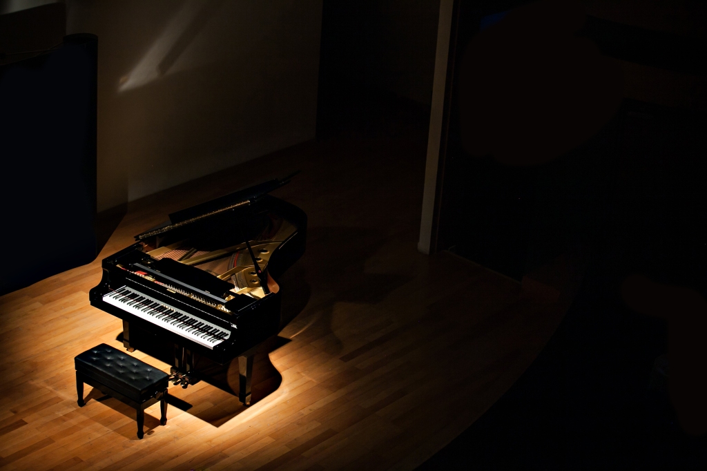 A piano stands on a stage.