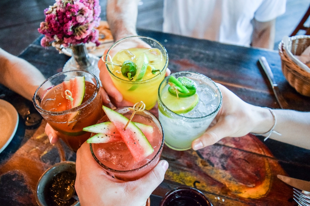 Friends toast their margaritas.