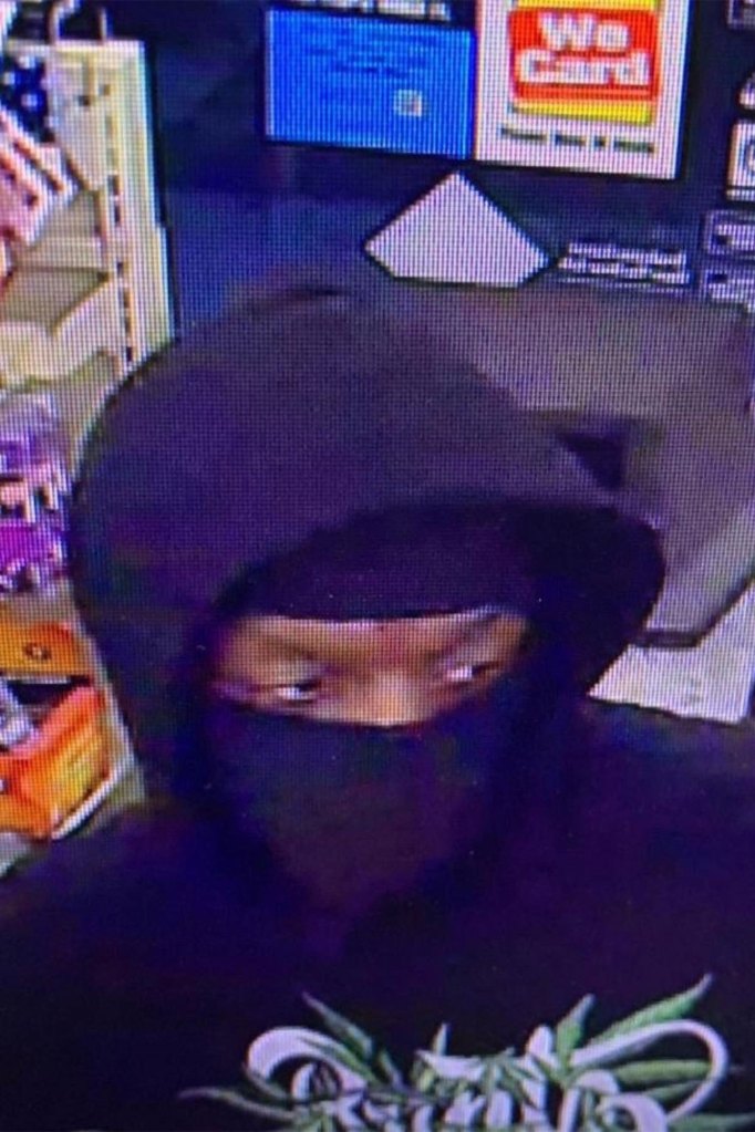 The suspect wears a black hood and mask.