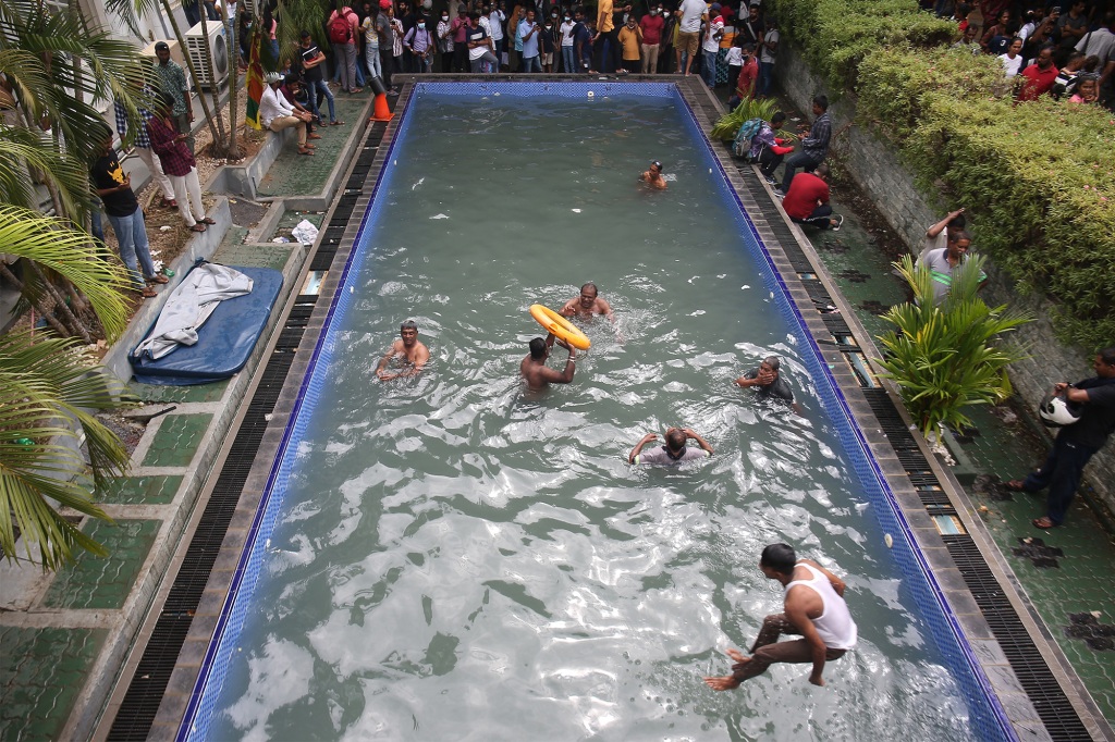 People swimming in the pool at the presidential palace in Colombo on July 10, 2022.