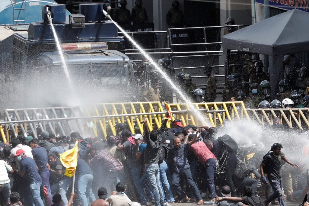 Police spraying water to control a demonstration outside of the presidential palace.