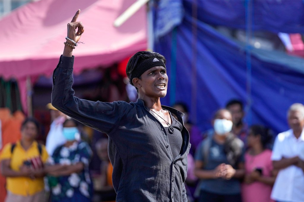 A protester shouts anti government slogans at the ongoing protest site outside Gotabaya Rajapaksa's office three days after it was stormed by anti government protesters in Colombo, Sri Lanka, Tuesday, July 12, 2022. Protesters have been occupying the seaside office of the president and official homes of the president and prime minister. (AP Photo/Eranga Jayawardena)


