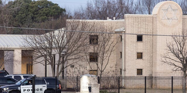 Police gather in front of the Congregation Beth Israel synagogue, Sunday, Jan. 16, 2022, in Colleyville, Texas. In January, four were taken hostage by a pistol-wielding man during a Shabbat service. 