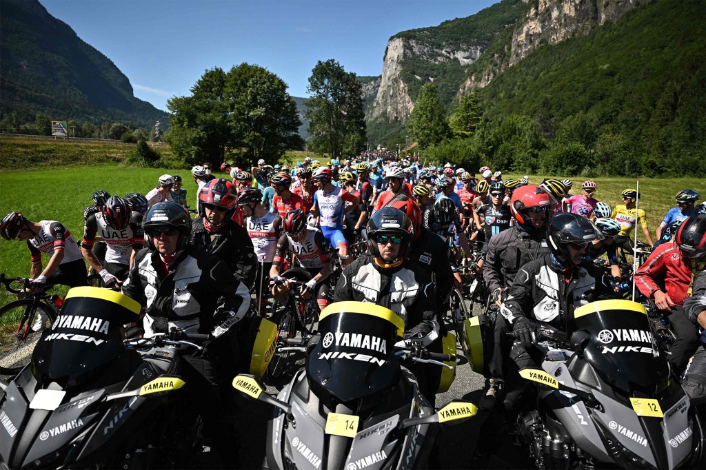 The pack of riders are temporarily immobilized by race regulators in the front due to protest action during the Tour de France on July 12, 2022. 