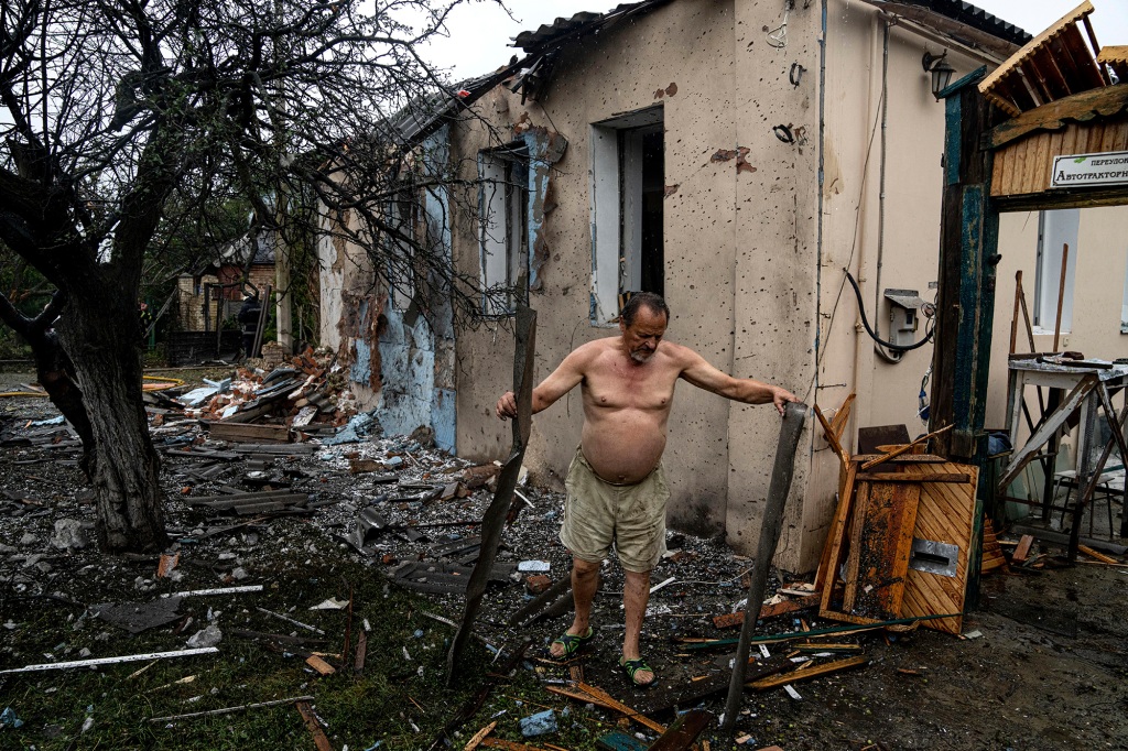A local man clears rubble from his house which was destroyed after a Russian attack in a residential neighborhood in downtown Kharkiv.
