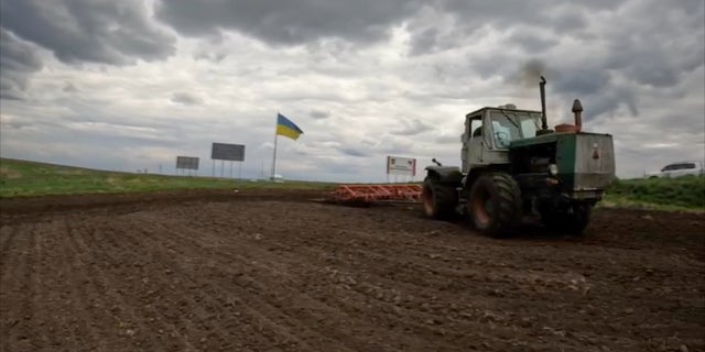 A tractor at work in Ukraine, which, together with Russia, made up 30% of the world's grain exports before the war.